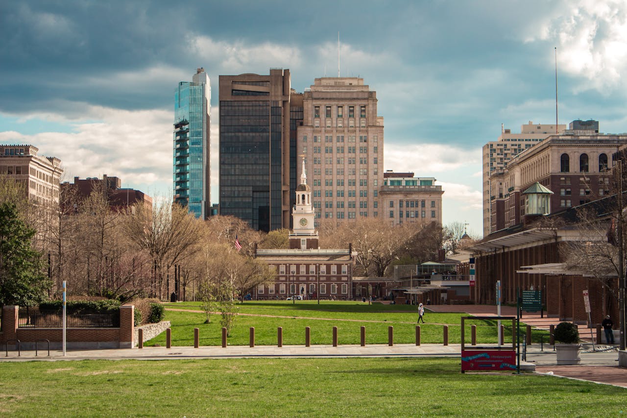 Portfolio Scenic view of Independence Hall with modern Philadelphia skyline in the background.
